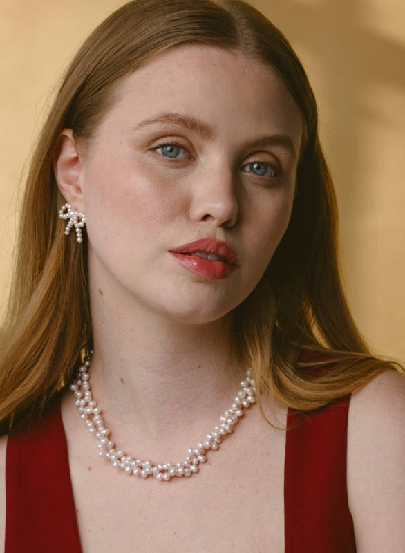 White Freshwater Pearl Bow Earrings - Model Image